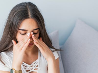 Young woman portraying sinus perforation after wisdom teeth extraction and possible sedation dentistry