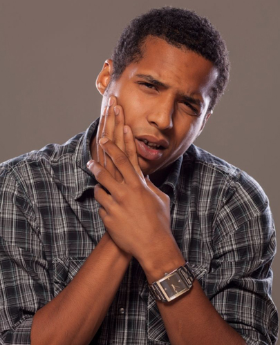 Young adult man portraying wisdom teeth pain